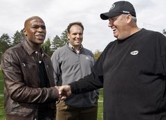 Floyd Mayweather, left, chats with New York Jets coach Rex Ryan while at practice Thursday. Ryan invited the undefeated boxer to speak to his team.